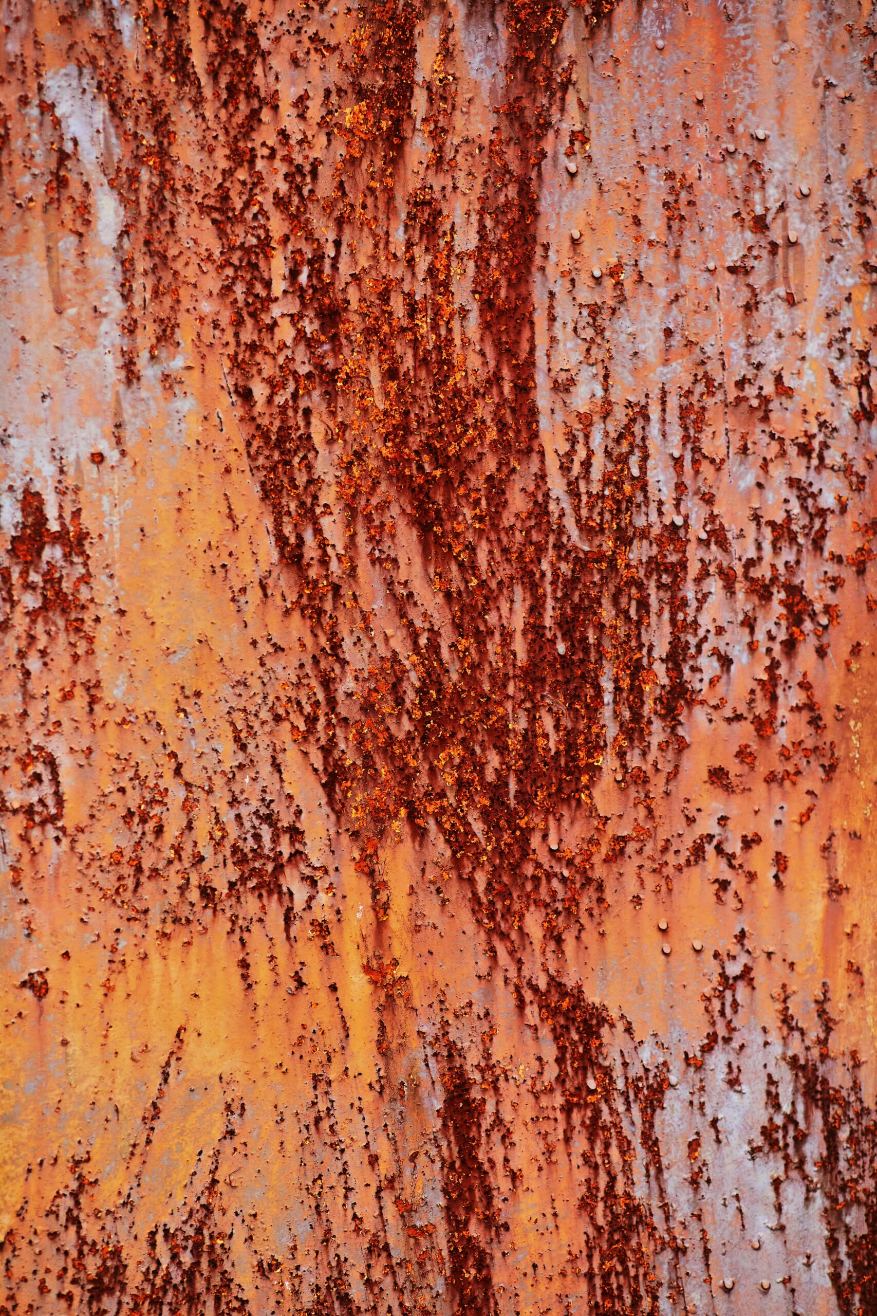 Rust-streaked copper surface