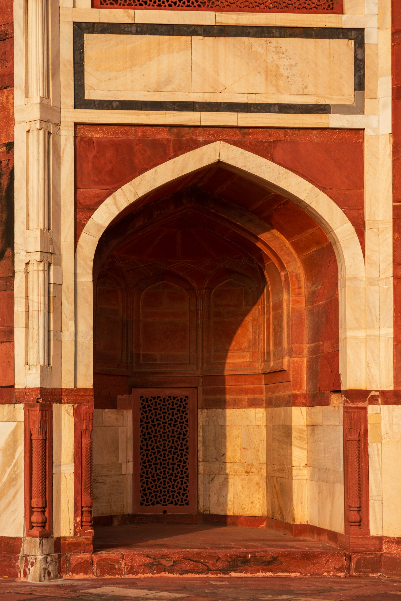 Red sandstone archway in warm light